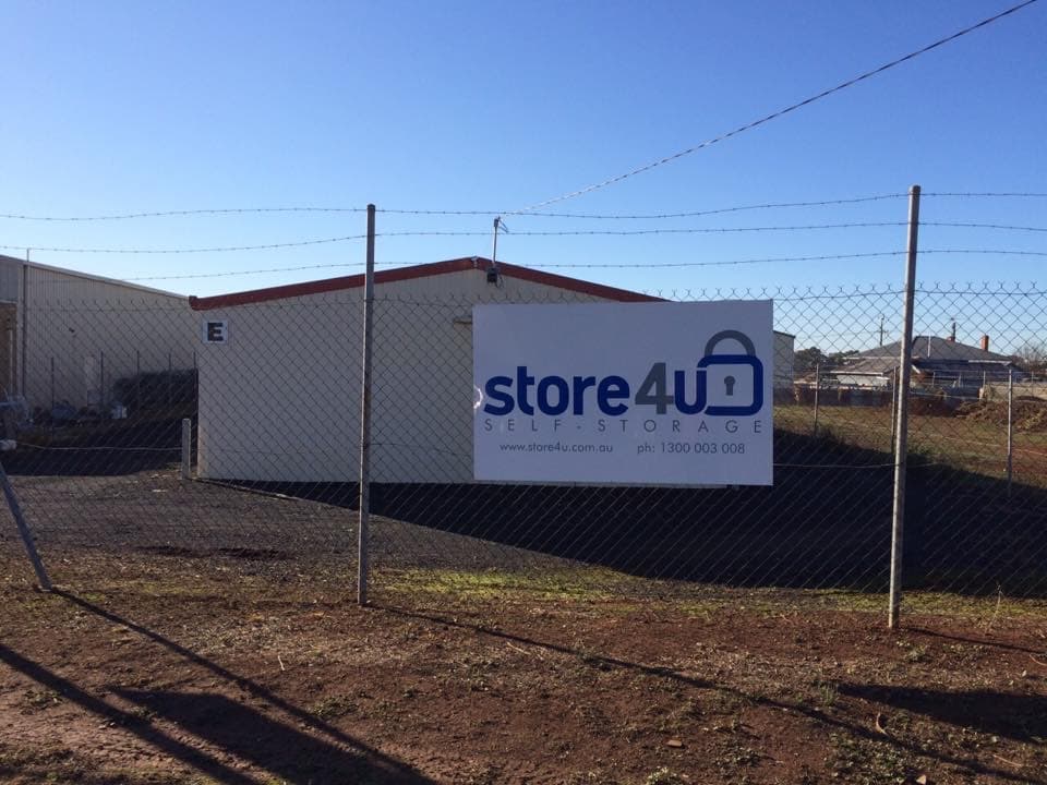 E block at 10 Smith Street, with the Store 4 U sign on the fence