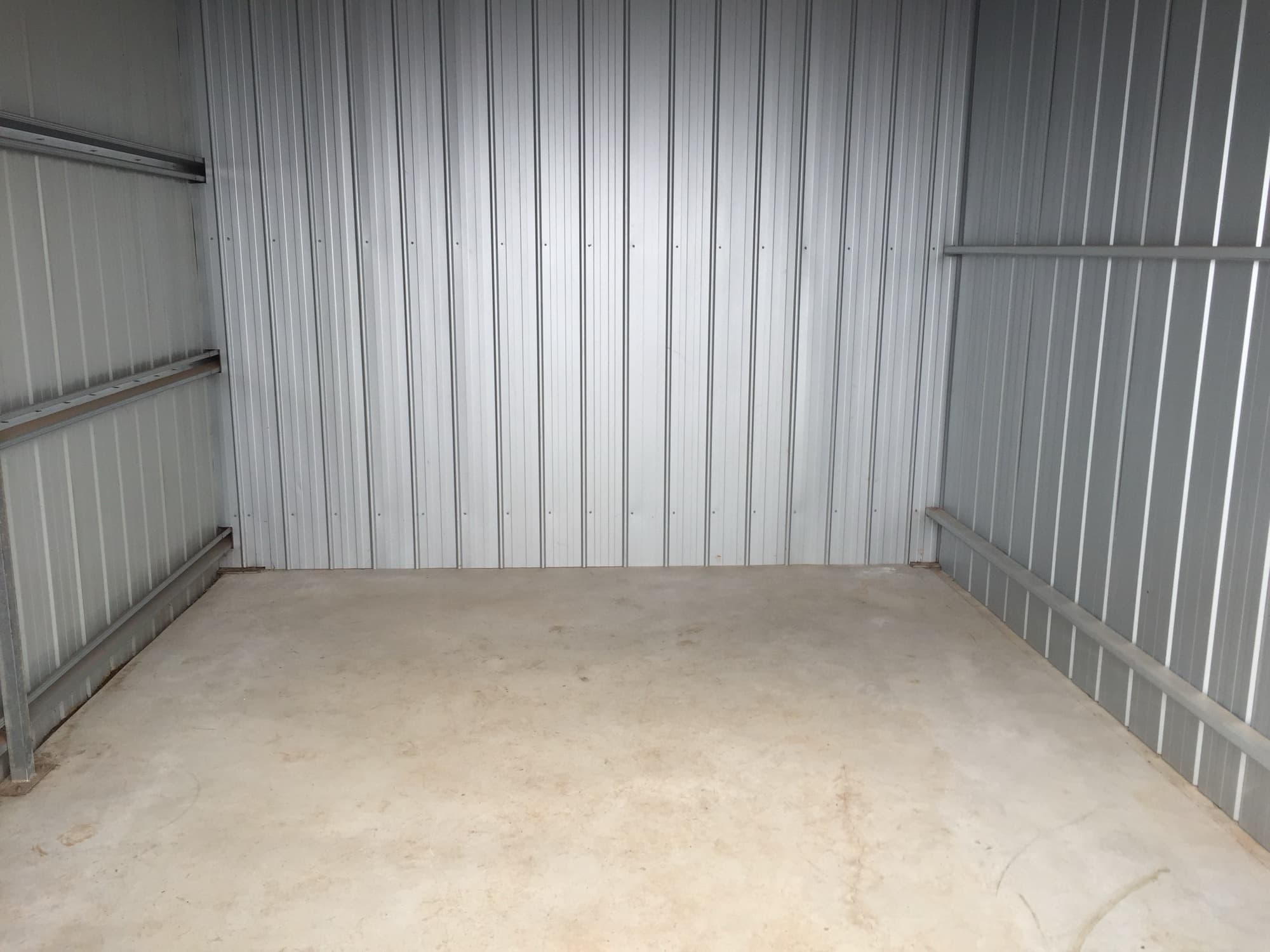 Inside an empty unit: concrete floor and steel walls